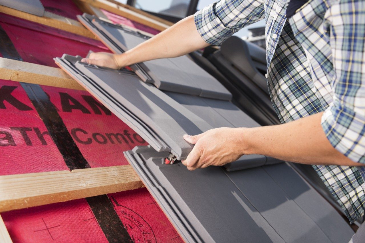 Roofer installing Actua roof tiles