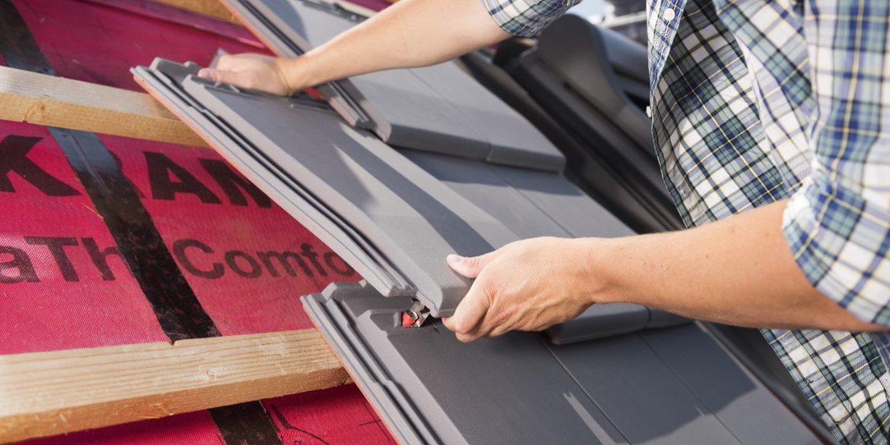 Roofer installing Actua roof tiles