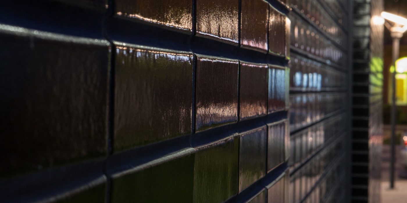 Multifamily setting with black glazed facing brick slips in Crakow