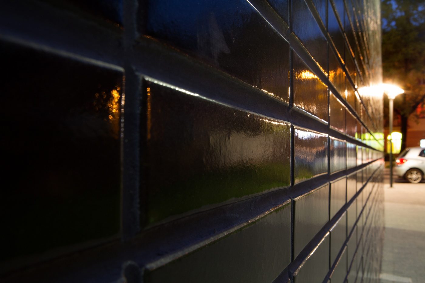 Multifamily setting with black glazed facing brick slips in Crakow
