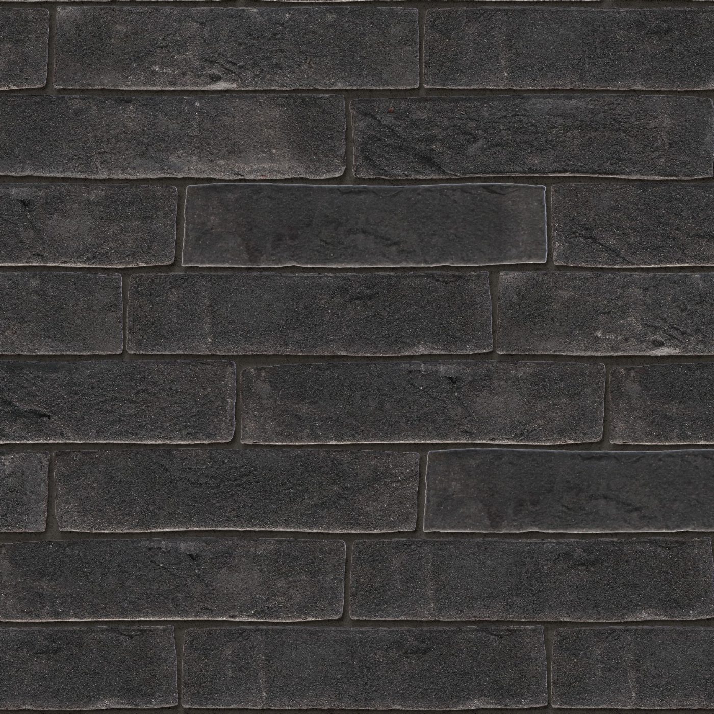 Tekstura cegieł i płytek klinkierowych Terca Grafit. Lico jest ręcznie formowane, utrzymane w odcieniach koloru grafitowego.