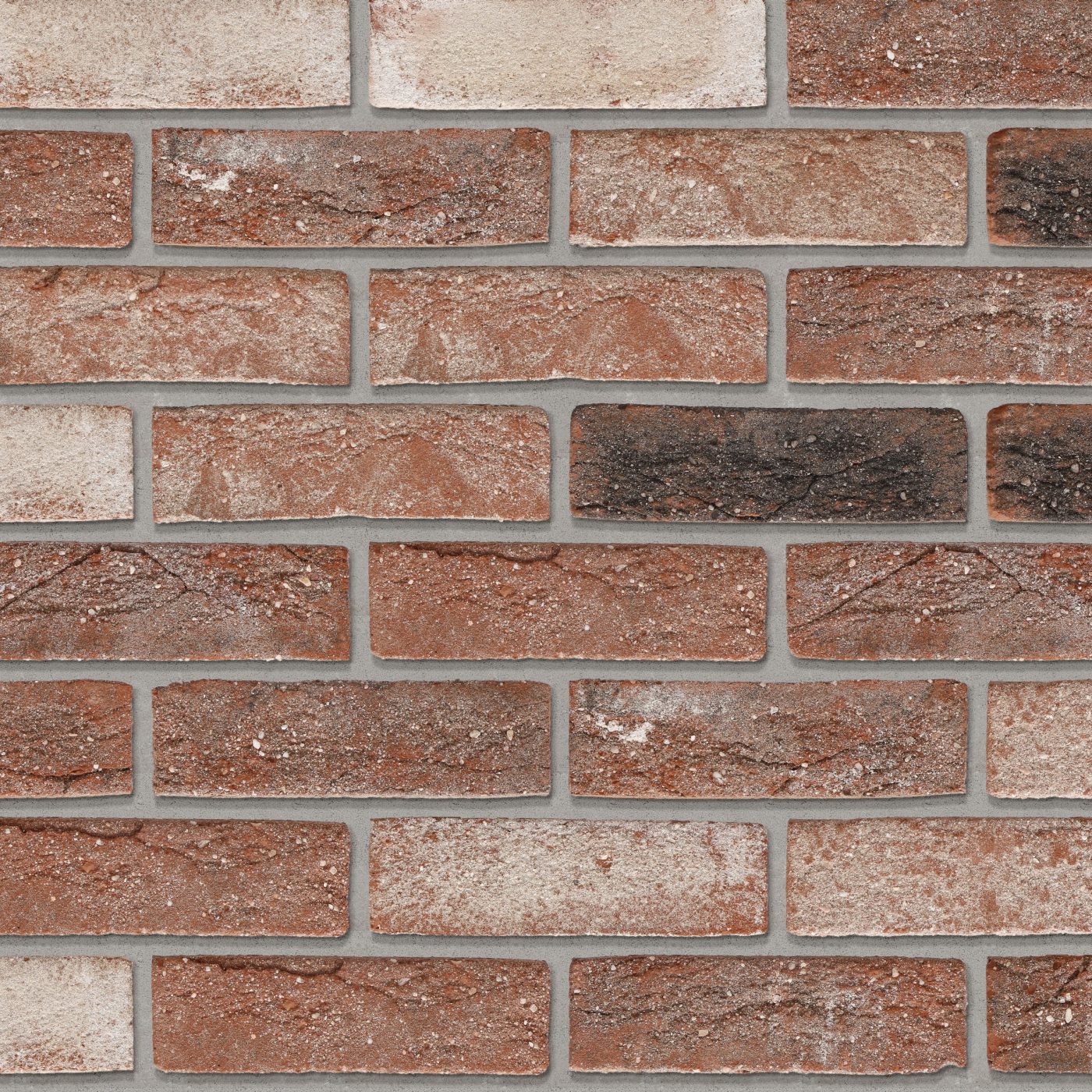 Tekstura cegieł i płytek klinkierowych Terca Barok. Jest to powierzchnia ręcznie formowana, utrzymana w wielobarwnych odcieniach czerwieni, beżu, brązu i czerni.