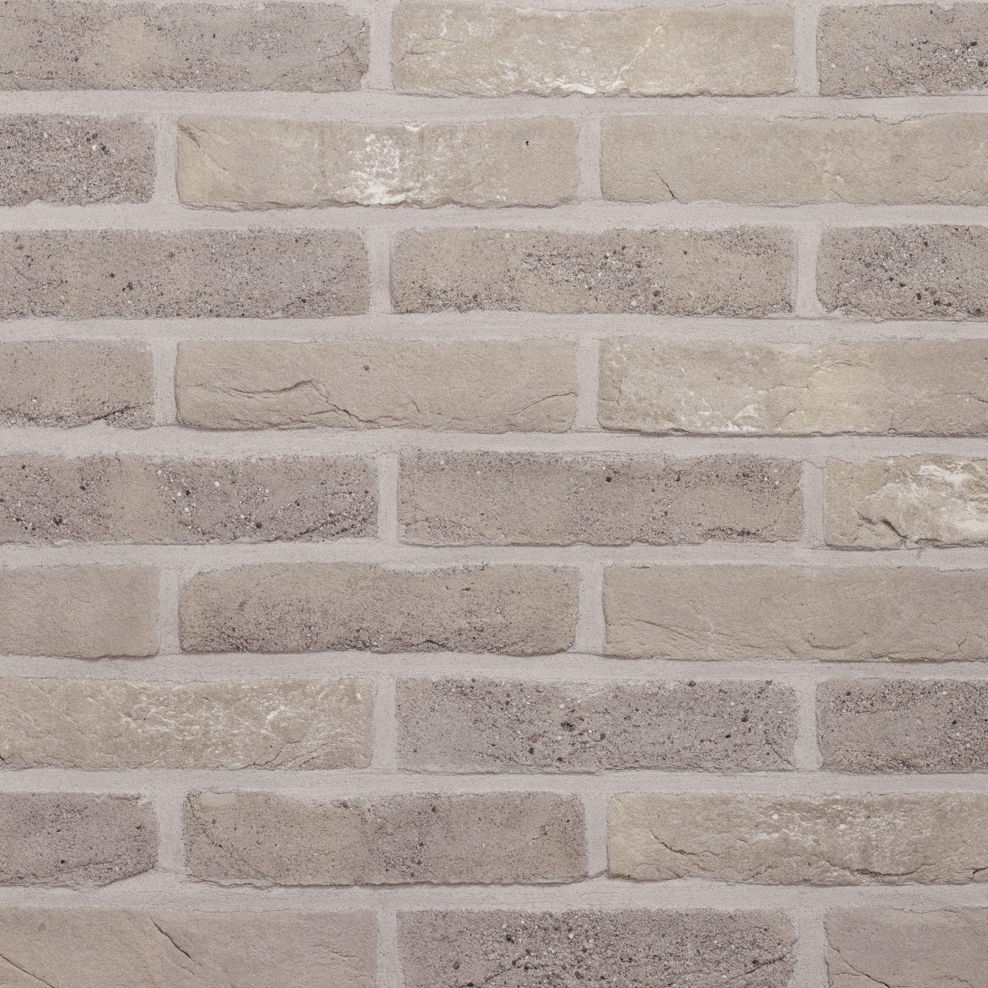 Tekstura cegieł i płytek klinkierowych Terca Agat. Powierzchnia lica jest ręcznie formowana, charakteryzuje się melanżem koloru szarego.